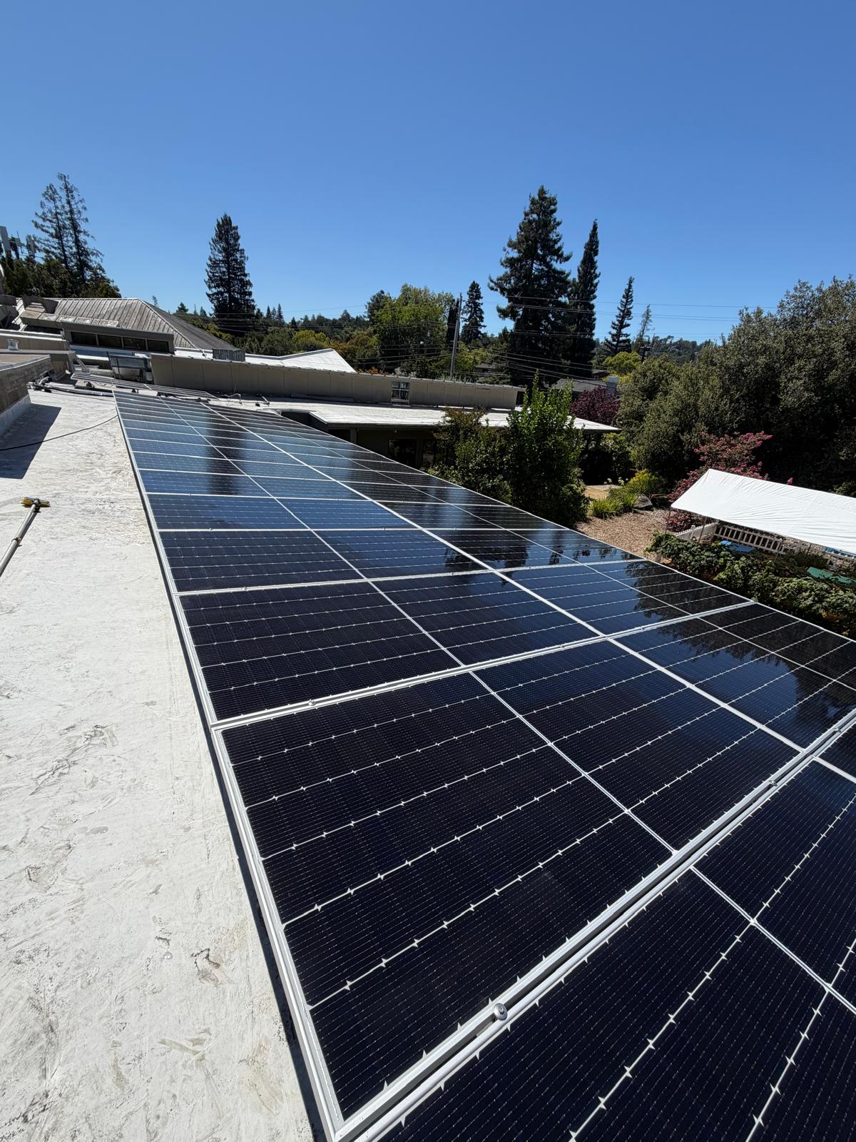 Rooftop solar panel array cleaning